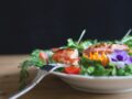 serving of salad and fish on white plate