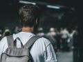 man carrying backpack standing